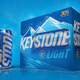 Keystone Light beer can next to case of beer